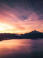 Wall Mural - sunrise at the lake on a pier with panorama view to the mountains