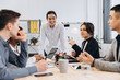 © anatoliycherkas - Group of multicultural businesspeople listening their boss speech - asian man manager talking to his team
