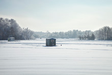 Ice Fishing Shacks At Minnesota Lake On A Bright Winter Morning