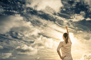 Young strong woman with fist up feeling victorious. People winning concept. 