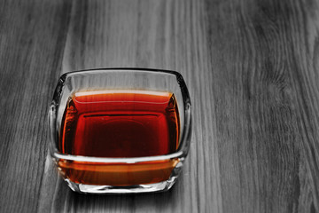 Soy sauce in a glass bowl on a wooden surface