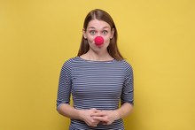 Funny Young Girl With A Red Clown Nose