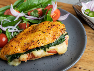 Wall Mural - Baked chicken fillet stuffed with spinach, tomatoes and cheese