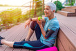 © Dragana Gordic - Portrait of a beautiful older woman with green healthy food after workout. Portrait of fit mature woman smiling while holding an apple and bottle of water. Sporty senior woman