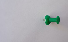 Green Pin, Attached To A White Empty Paper, Oriented To The Right