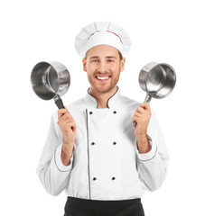 Canvas Print - Handsome male chef with saucepans on white background