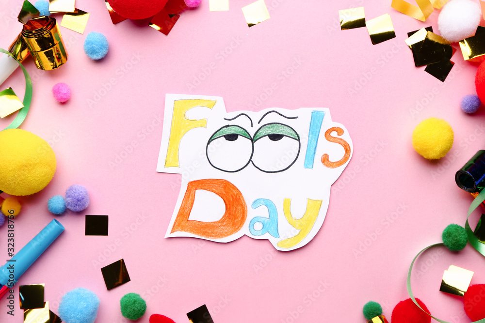 Party decor with text FOOL'S DAY on color background