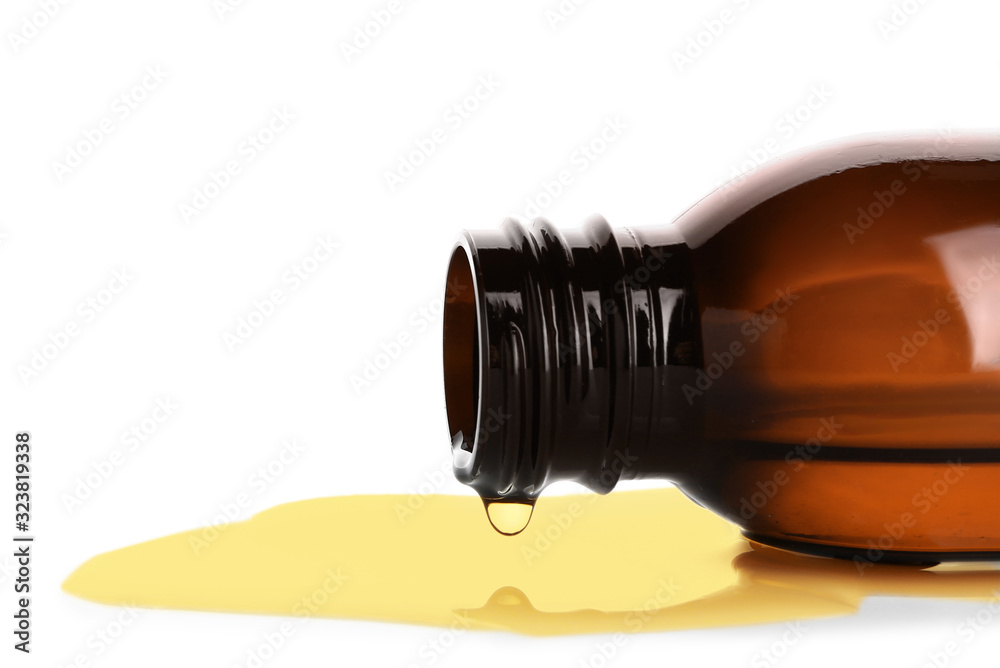 Bottle with spilled fish oil on white background