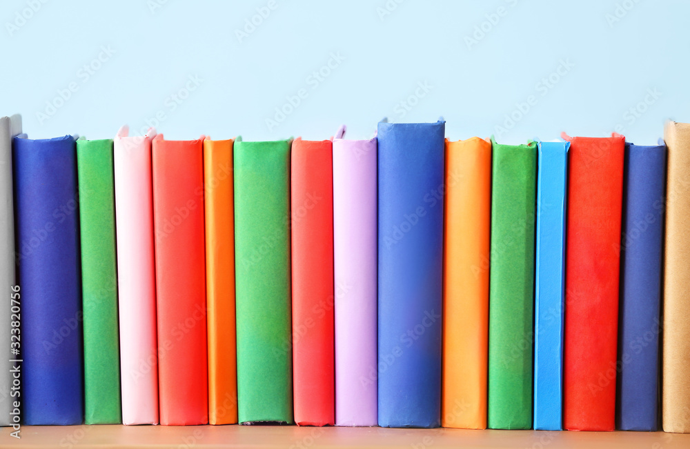 Many books on table against light background