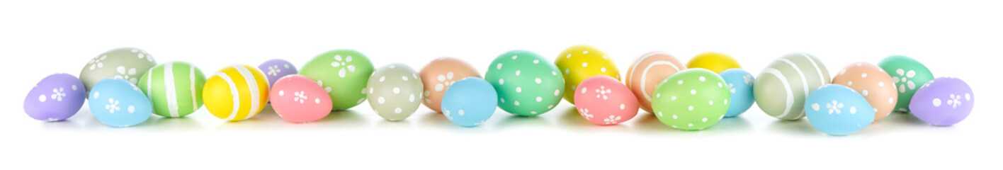 Poster - Easter eggs scattered forming a long border isolated on a white background. Pastel colors.
