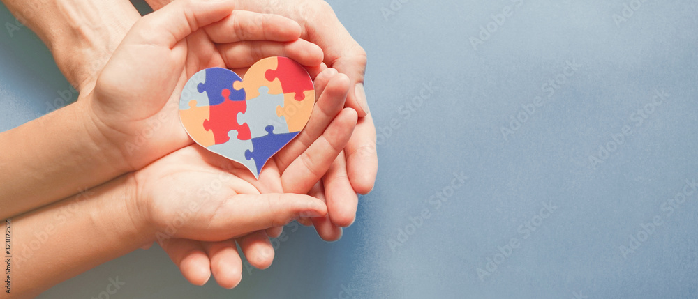 Adult and chiild hands holding jigsaw puzzle heart shape, Autism awareness,Autism spectrum disorder family support concept, World Autism Awareness Day - obrazy, fototapety, plakaty 