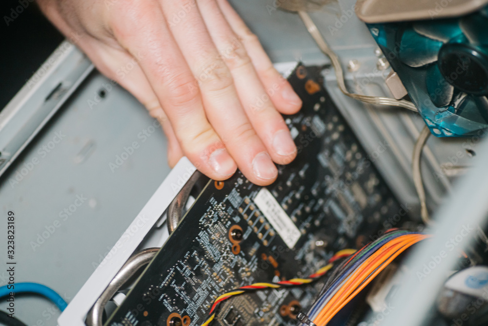 Professional man repairing and assembling computer inside. Male hand ...