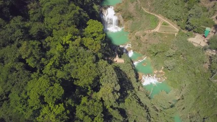 Wall Mural - Aerial view to powerful waterfall with blue natural pools