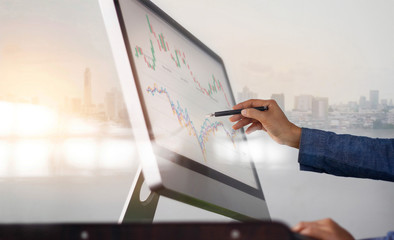 Poster - Businessman and pen in hand analyzing sales data and economic growth graph on computer screen. Business strategy, stock market, Digital marketing.