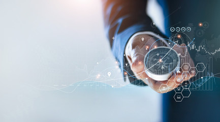 Leinwandbilder - Businessman holding a navigation compass in hand and define marketing direction and analysis growth sale data with search customer global network, Abstract business.