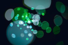 Graphic Illustration Of Different Shades Of Green Dots With A Black Background