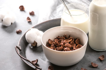 Milk with chocolate corn flakes cereal in bowl