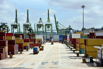 View on the container terminal in Singapore, boxes with cargo waiting to be loaded on the container vessels. 