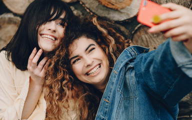 The upper view of two sisters who have not seen for a long time and now are making a common photo