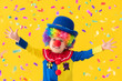 © Sunny studio - Funny kid clown playing against yellow background