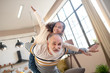 © zinkevych - Dark-skinned cute girl sitting on her granddads back with her arms to the sides