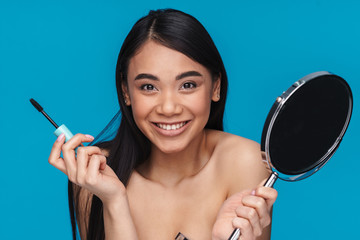 Poster - Woman posing isolated over blue wall background