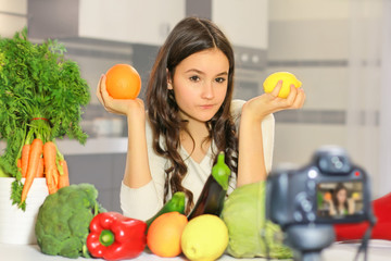 Teenage blogger explains to her followers how to eat healthy. Concept of communication among young people on the importance of healthy eating habits, vitamins and calories.