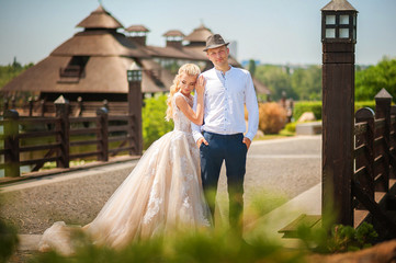 Wall Mural - The bride and groom on a walk in the summer. Newlyweds in the park. Summer wedding in nature, Ukraine, Dnipro.