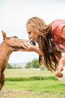 © MACO - Young girl kisses nose of young colt. Bridger, Montana, USA