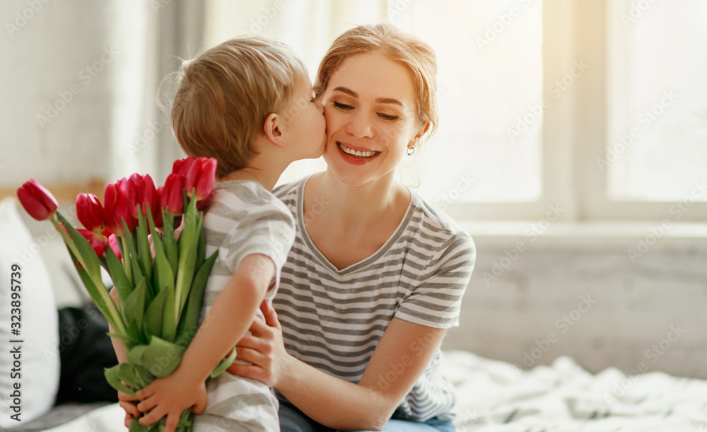 happy mother's day! child son gives flowers for  mother on holiday . - obrazy, fototapety, plakaty 