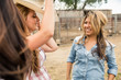 © MACO - Young cowgirls having fun on the ranch, smiling. Bridger, Montana, USA