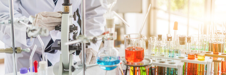 Wall Mural - scientist testing some blood sample at laboratory with lab glassware on the table. science or medica