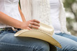 © MACO - Close-up of cowboy hat held by two western girls sitting on a fence. Bridger, Montana, USA