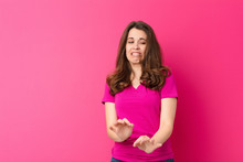 Young Pretty Woman Feeling Disgusted And Nauseous, Backing Away From Something Nasty, Smelly Or Stinky, Saying Yuck Against Pink Wall