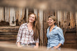 © MACO - Two western girls leaning on a barn and laughing. Bridger, Montana, USA