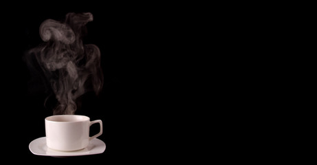 White coffee cup on plate with smoke isolated on black background in studio With copy space.