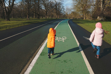 Wall Mural - boy and girl running in park