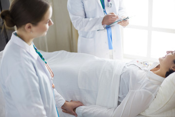 doctor or nurse talking to patient in hospital