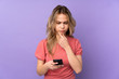 © luismolinero - Teenager Russian girl isolated on purple background thinking and sending a message