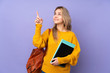 © luismolinero - Teenager Russian student girl isolated on purple background pointing with the index finger a great idea