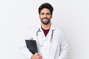 Young handsome man with beard over isolated white background wearing a doctor gown and holding a folder