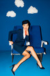 © LIGHTFIELD STUDIOS - shocked african american flight attendant sitting on seat on blue background with clouds