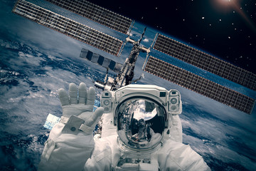 Canvas Print - astronaut and space station against earth. the elements of this image furnished by nasa.