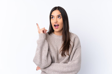 Young brunette woman over isolated white background thinking an idea pointing the finger up