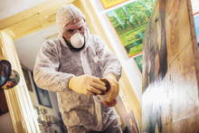 Restorer Working On The Painting At Restoration Workshop