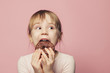 © millaf - Funny little child girl with donut. on pink background