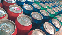 Rows Of Colorful Metal Cans With Soda Drink In Shop