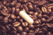 caffeine pills. pill on the background of coffee beans.