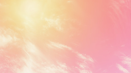 Wall Mural - Sunny orange pink sky background. Beautiful warm sky with clouds. Toned photo, 16:9 panoramic format