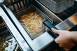 Deep fryer for potatoes in kitchen